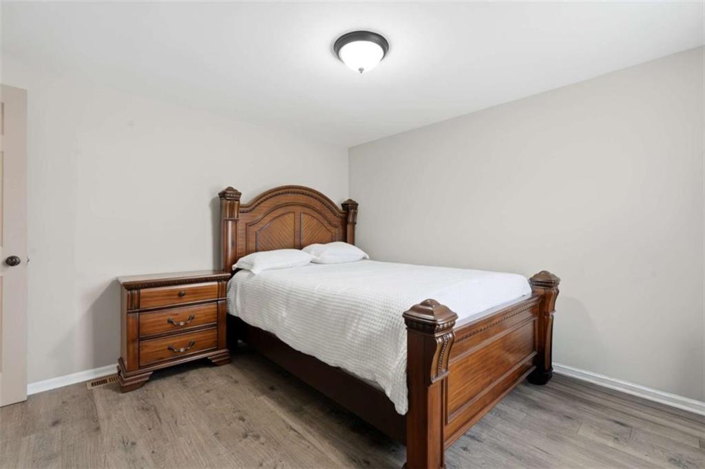 1295 Double Bridges Road Winder, GA 30680 - Photo 28 of 59 a bedroom with a bed and a dresser