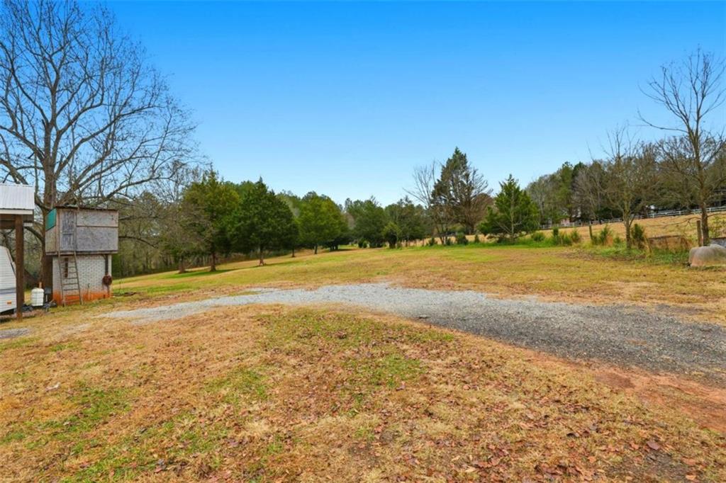 1295 Double Bridges Road Winder, GA 30680 - Photo 33 of 59 a view of a swimming pool and trees in the background