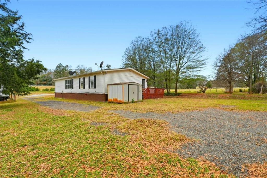 1295 Double Bridges Road Winder, GA 30680 - Photo 36 of 59 a house view with swimming pool in front of it
