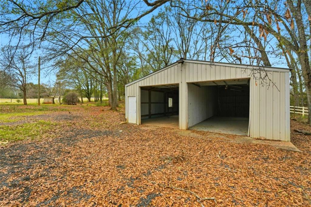 1295 Double Bridges Road Winder, GA 30680 - Photo 38 of 59 a front view of a house with a yard and garage