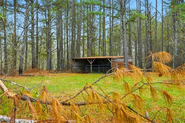 a view of yard with entertaining space and trees