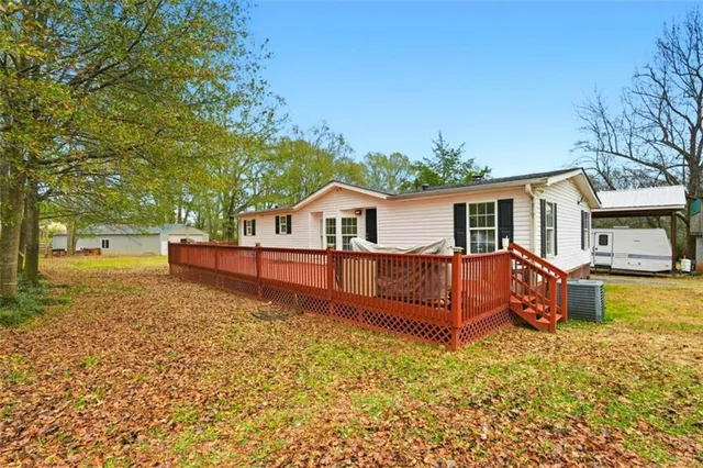 a view of a house with a wooden deck