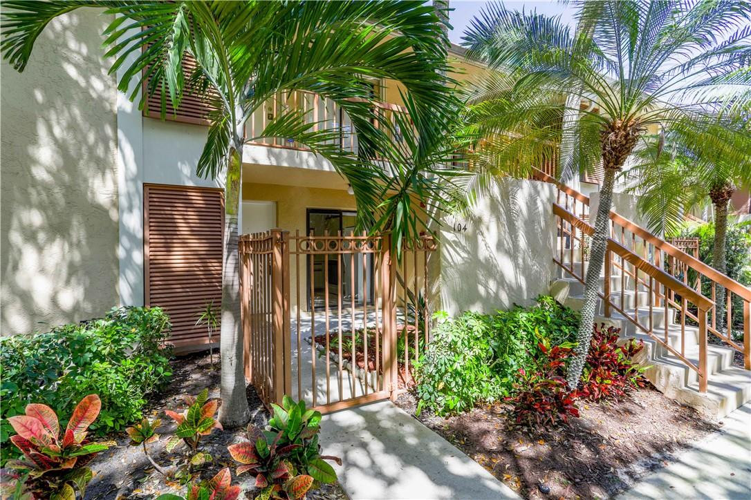 3939 Northeast 5th Avenue, Unit F104 Boca Raton, FL 33431 - Photo 1 of 34 a front view of a house with a tree