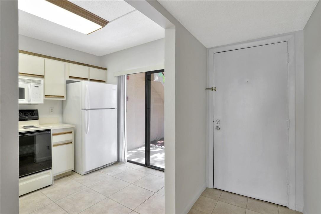 3939 Northeast 5th Avenue, Unit F104 Boca Raton, FL 33431 - Photo 11 of 34 a kitchen with stainless steel appliances a refrigerator and a sink