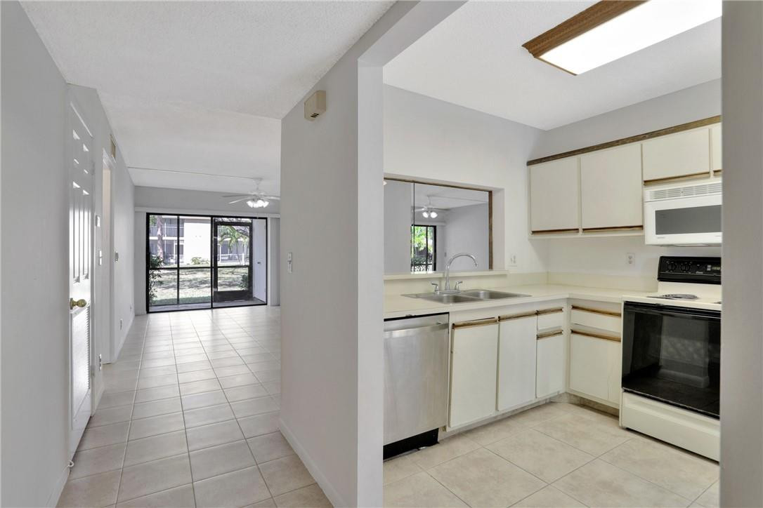 3939 Northeast 5th Avenue, Unit F104 Boca Raton, FL 33431 - Photo 13 of 34 a kitchen with stainless steel appliances granite countertop a stove and a sink