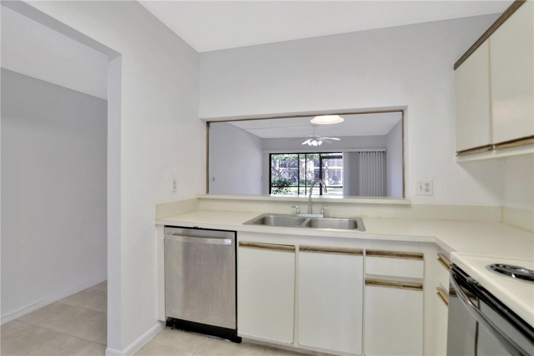 3939 Northeast 5th Avenue, Unit F104 Boca Raton, FL 33431 - Photo 15 of 34 a kitchen with a sink and cabinets