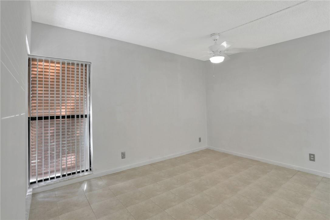 3939 Northeast 5th Avenue, Unit F104 Boca Raton, FL 33431 - Photo 18 of 34 an empty room with windows