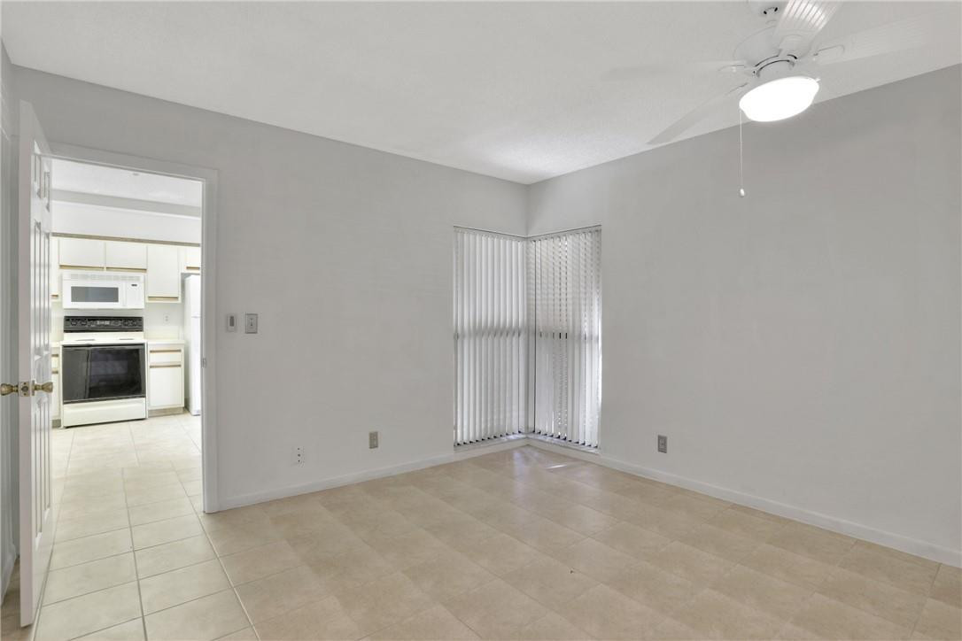 3939 Northeast 5th Avenue, Unit F104 Boca Raton, FL 33431 - Photo 20 of 34 an empty room with a kitchen and a sink