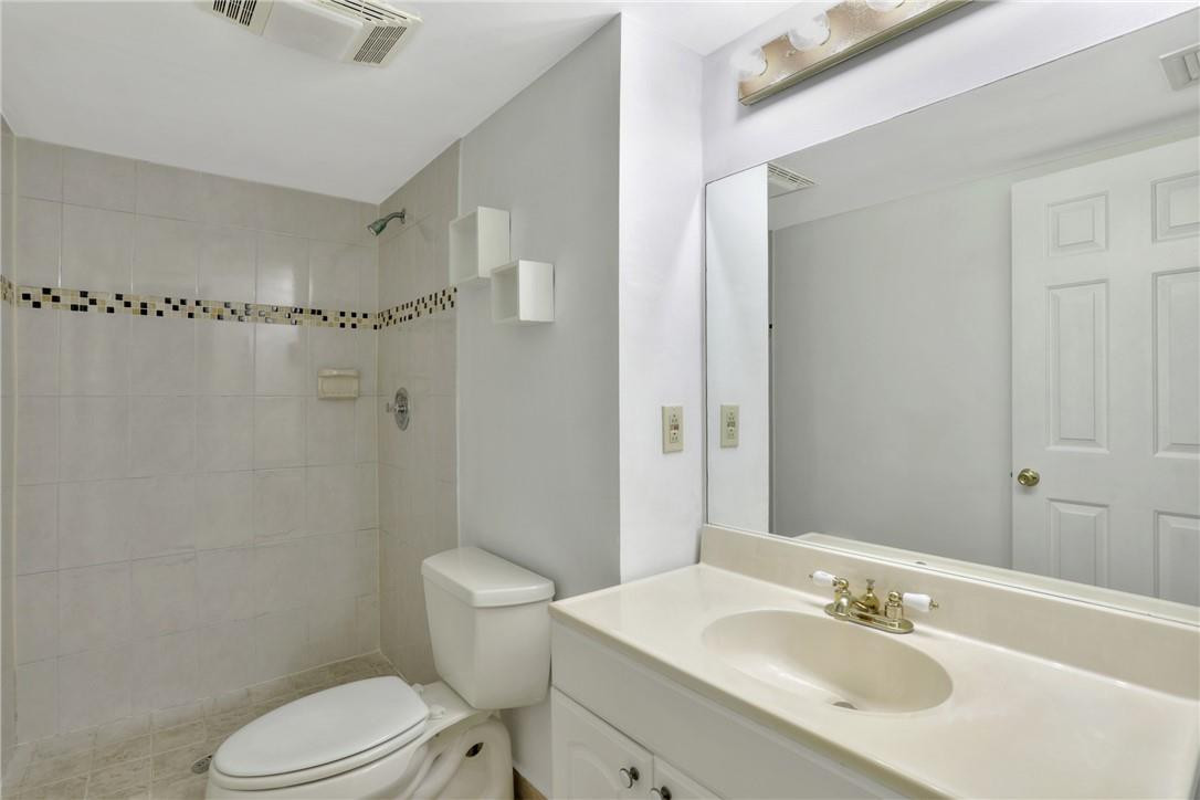 3939 Northeast 5th Avenue, Unit F104 Boca Raton, FL 33431 - Photo 21 of 34 a bathroom with a sink toilet and shower