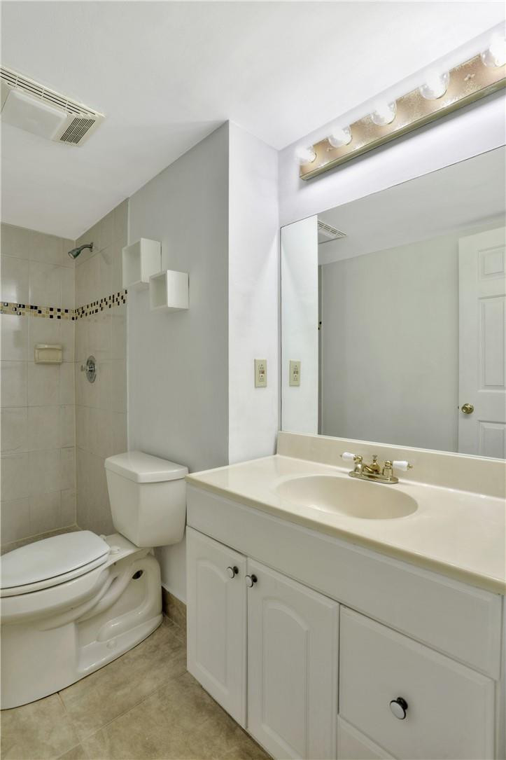 3939 Northeast 5th Avenue, Unit F104 Boca Raton, FL 33431 - Photo 22 of 34 a bathroom with a sink a toilet and shower