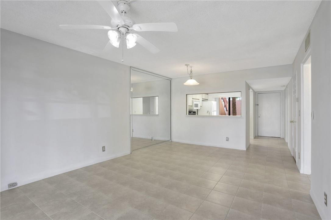 3939 Northeast 5th Avenue, Unit F104 Boca Raton, FL 33431 - Photo 25 of 34 an empty room with fan and ceiling fan