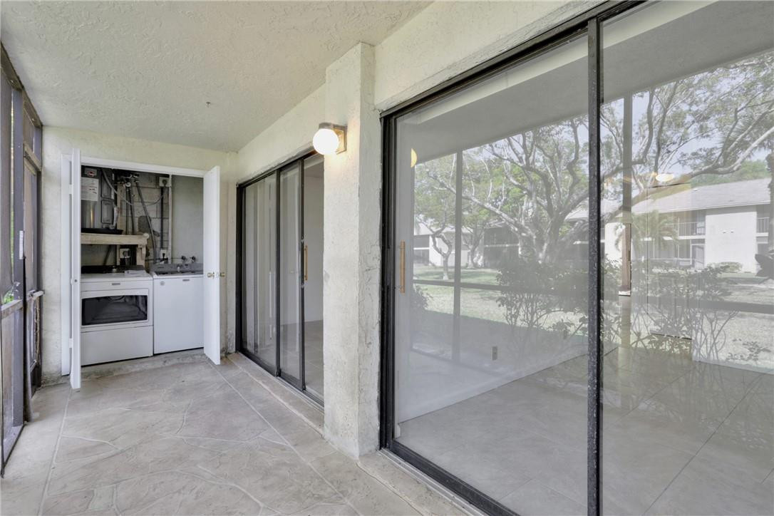3939 Northeast 5th Avenue, Unit F104 Boca Raton, FL 33431 - Photo 27 of 34 a view of a hallway with kitchen and entryway