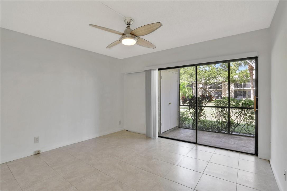 3939 Northeast 5th Avenue, Unit F104 Boca Raton, FL 33431 - Photo 31 of 34 a view of an empty room with windows
