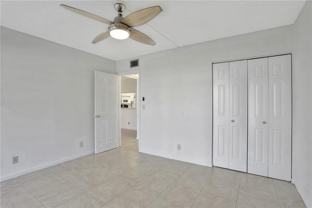 3939 Northeast 5th Avenue, Unit F104 Boca Raton, FL 33431 - Photo 32 of 34 an empty room with fan and a ceiling fan