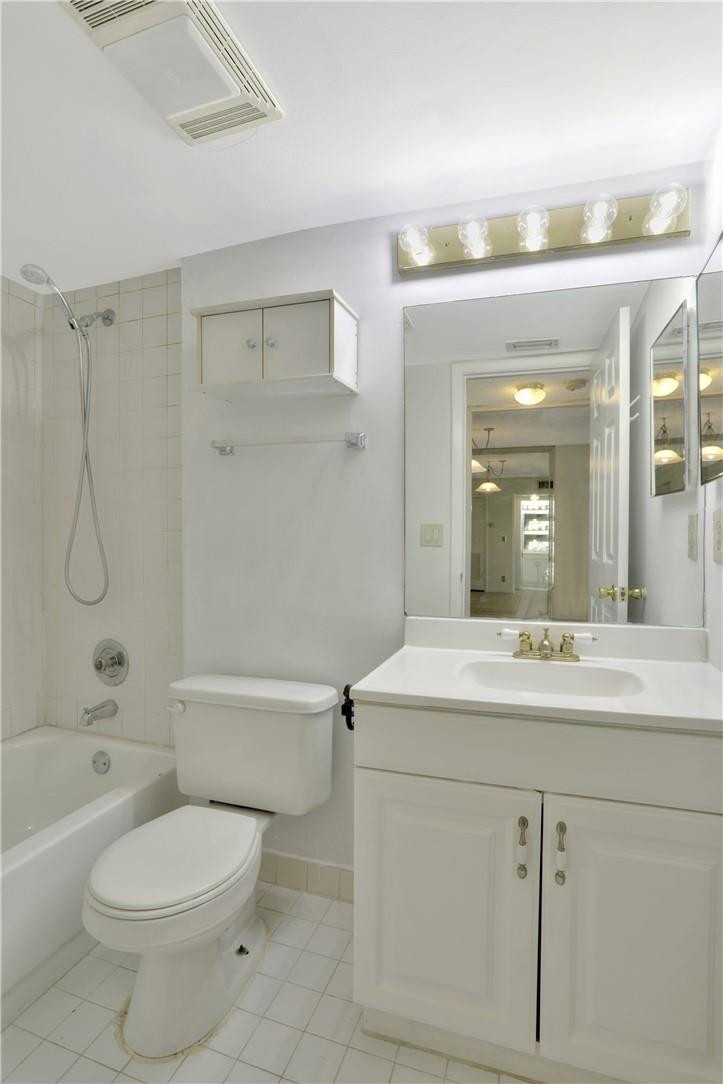 3939 Northeast 5th Avenue, Unit F104 Boca Raton, FL 33431 - Photo 33 of 34 a bathroom with a sink a toilet and shower