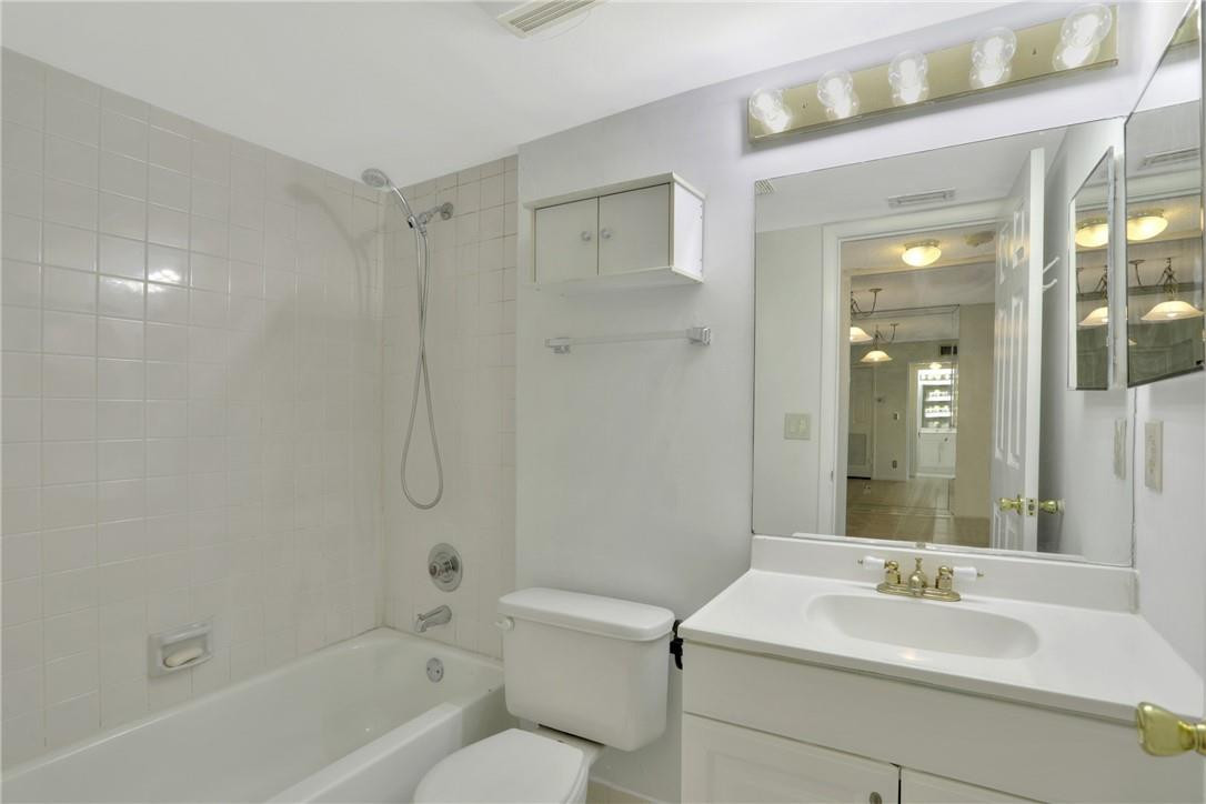 3939 Northeast 5th Avenue, Unit F104 Boca Raton, FL 33431 - Photo 34 of 34 a bathroom with a sink toilet and shower