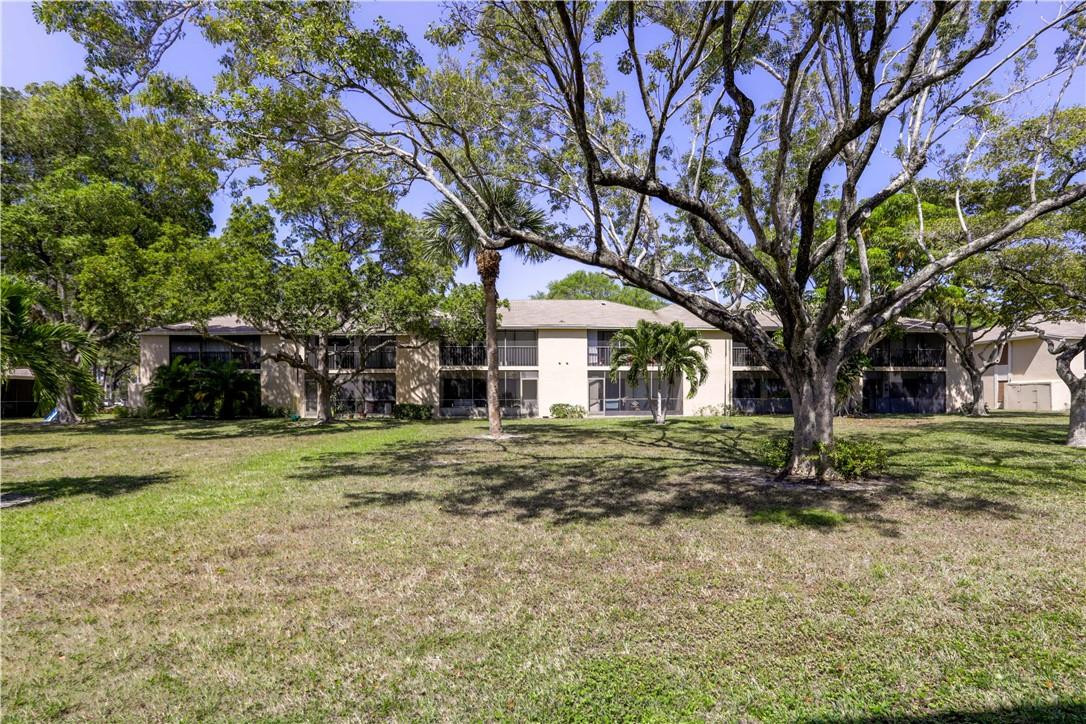 3939 Northeast 5th Avenue, Unit F104 Boca Raton, FL 33431 - Photo 6 of 34 a view of a house with a yard