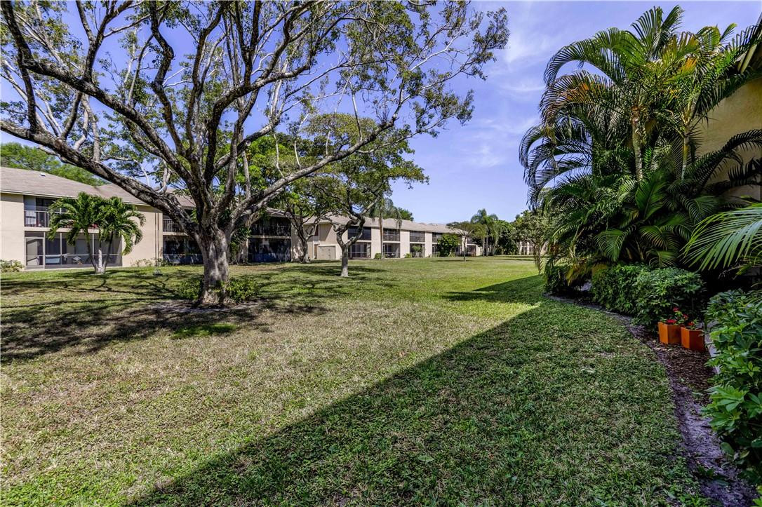 3939 Northeast 5th Avenue, Unit F104 Boca Raton, FL 33431 - Photo 7 of 34 a view of a house with a backyard