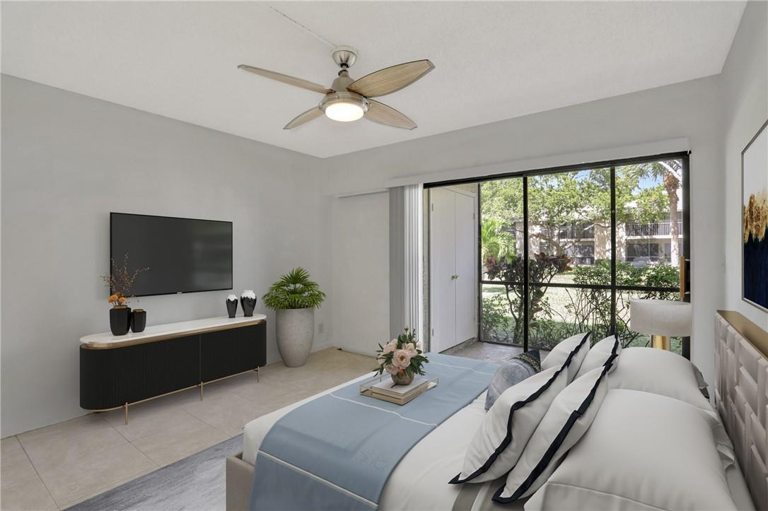 3939 Northeast 5th Avenue, Unit F104 Boca Raton, FL 33431 - Photo 10 of 34 a living room with furniture and a flat screen tv