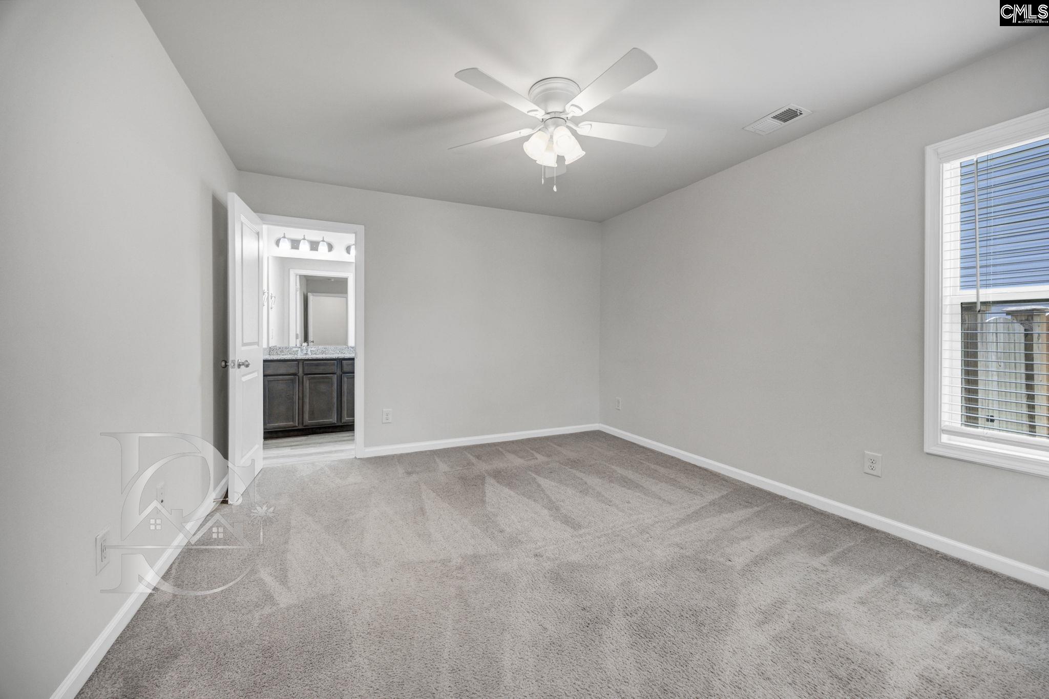 235 Drayton Hall Road West Columbia, SC 29172 - Photo 14 of 24 an empty room with windows and ceiling fan