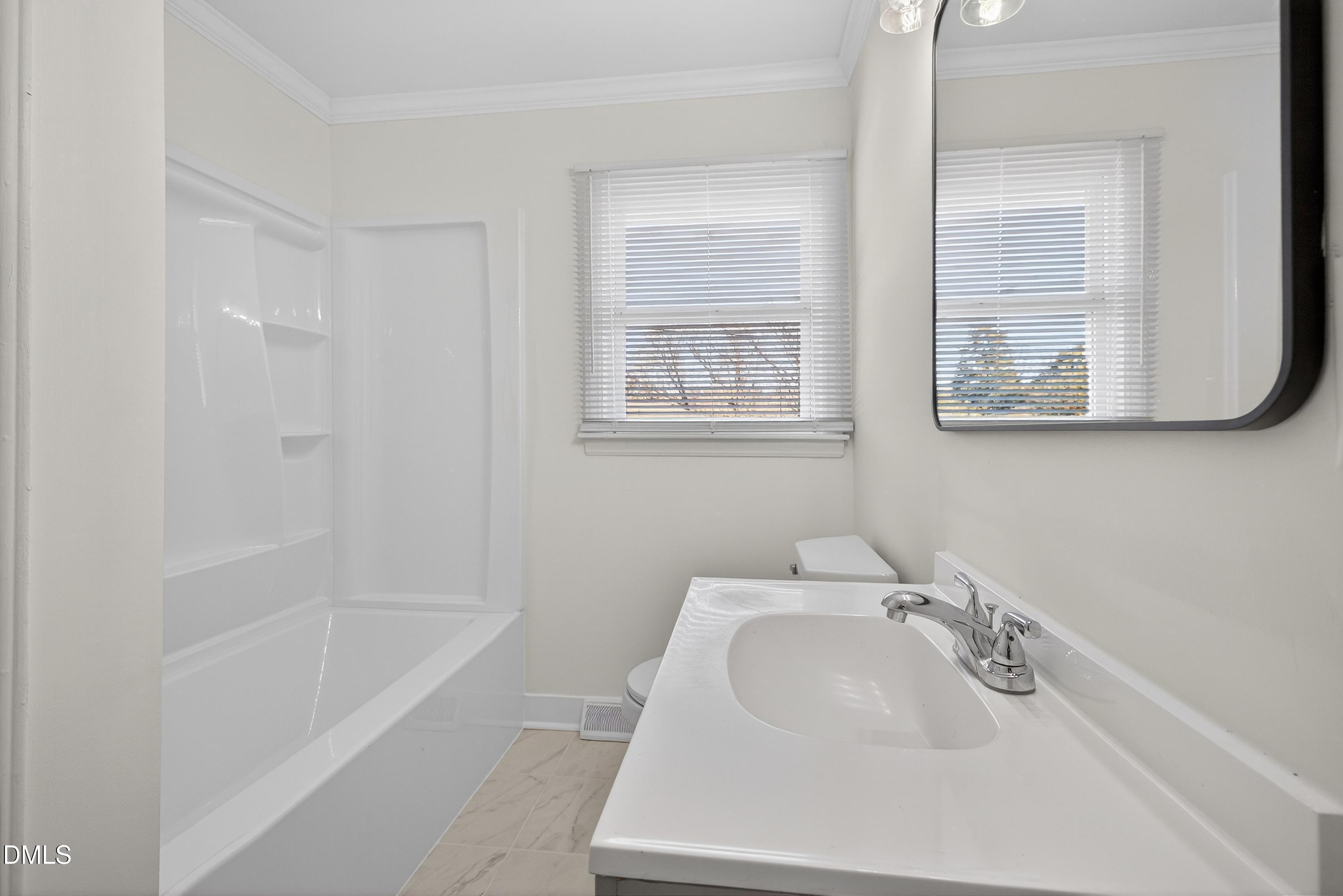 302 Normandy Street Durham, NC 27707 - Photo 15 of 29 a bathroom with bathtub sink and mirror