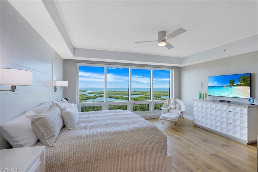 13915 Old Coast Road, Unit 1601 Naples, FL 34110 - Photo 14 of 37 a bed room with a bed and a large window