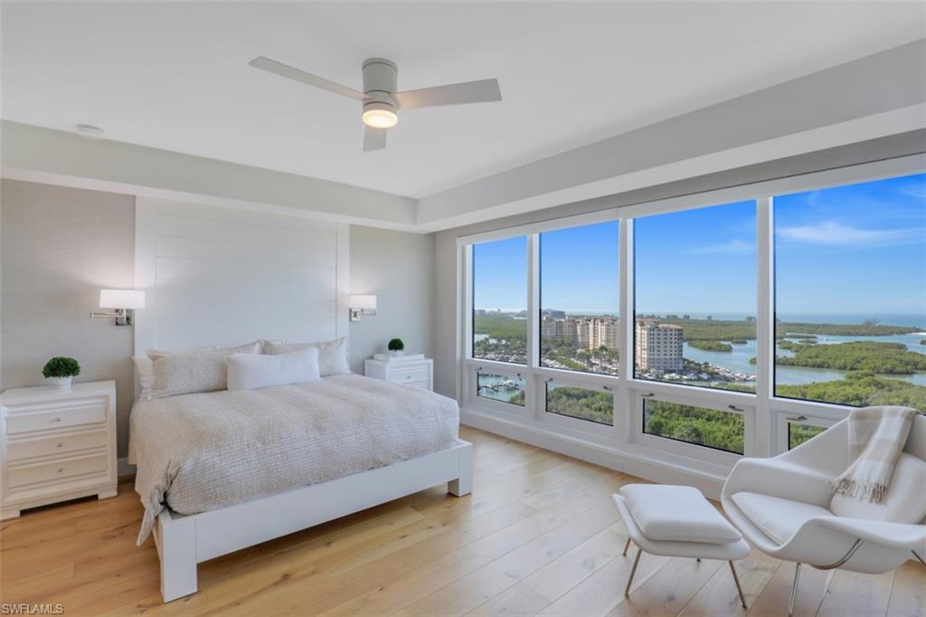 13915 Old Coast Road, Unit 1601 Naples, FL 34110 - Photo 15 of 37 a bedroom with a bed and a large window with outer view