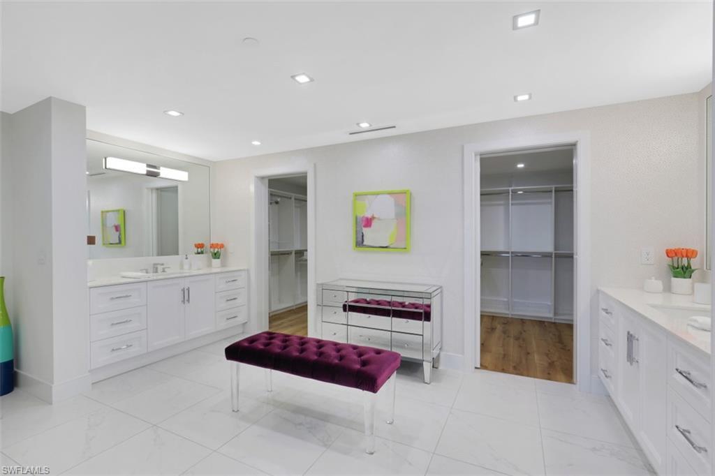 13915 Old Coast Road, Unit 1601 Naples, FL 34110 - Photo 16 of 37 a spacious bedroom with a bed and a view of cabinet