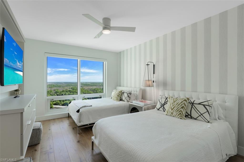 13915 Old Coast Road, Unit 1601 Naples, FL 34110 - Photo 20 of 37 a bedroom with two beds and a large window