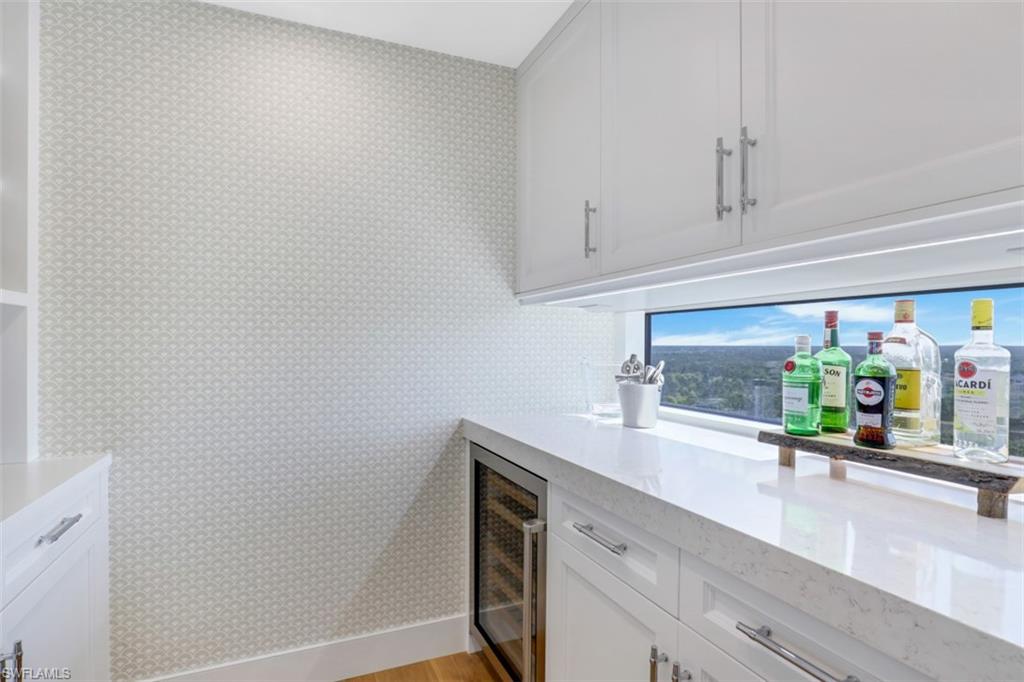 13915 Old Coast Road, Unit 1601 Naples, FL 34110 - Photo 22 of 37 a kitchen with stainless steel appliances a sink and cabinets