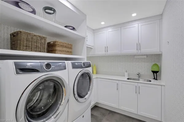 a kitchen with stainless steel appliances a sink and cabinets