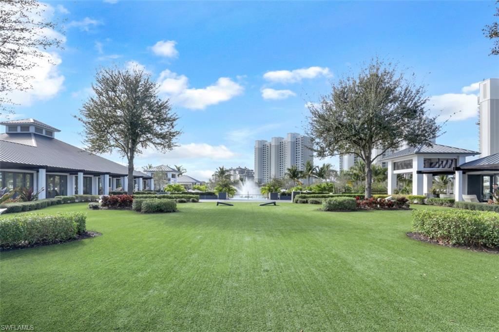 13915 Old Coast Road, Unit 1601 Naples, FL 34110 - Photo 30 of 37 a backyard of a house with table and chairs