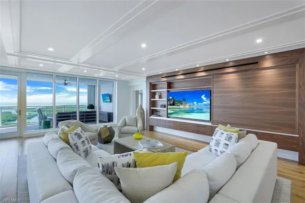 a living room with furniture and floor to ceiling window