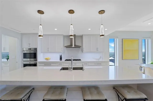 a kitchen with kitchen island a sink stainless steel appliances and cabinets