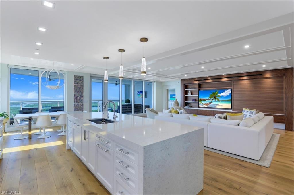 13915 Old Coast Road, Unit 1601 Naples, FL 34110 - Photo 37 of 37 a large kitchen with kitchen island a sink a counter space and living room view