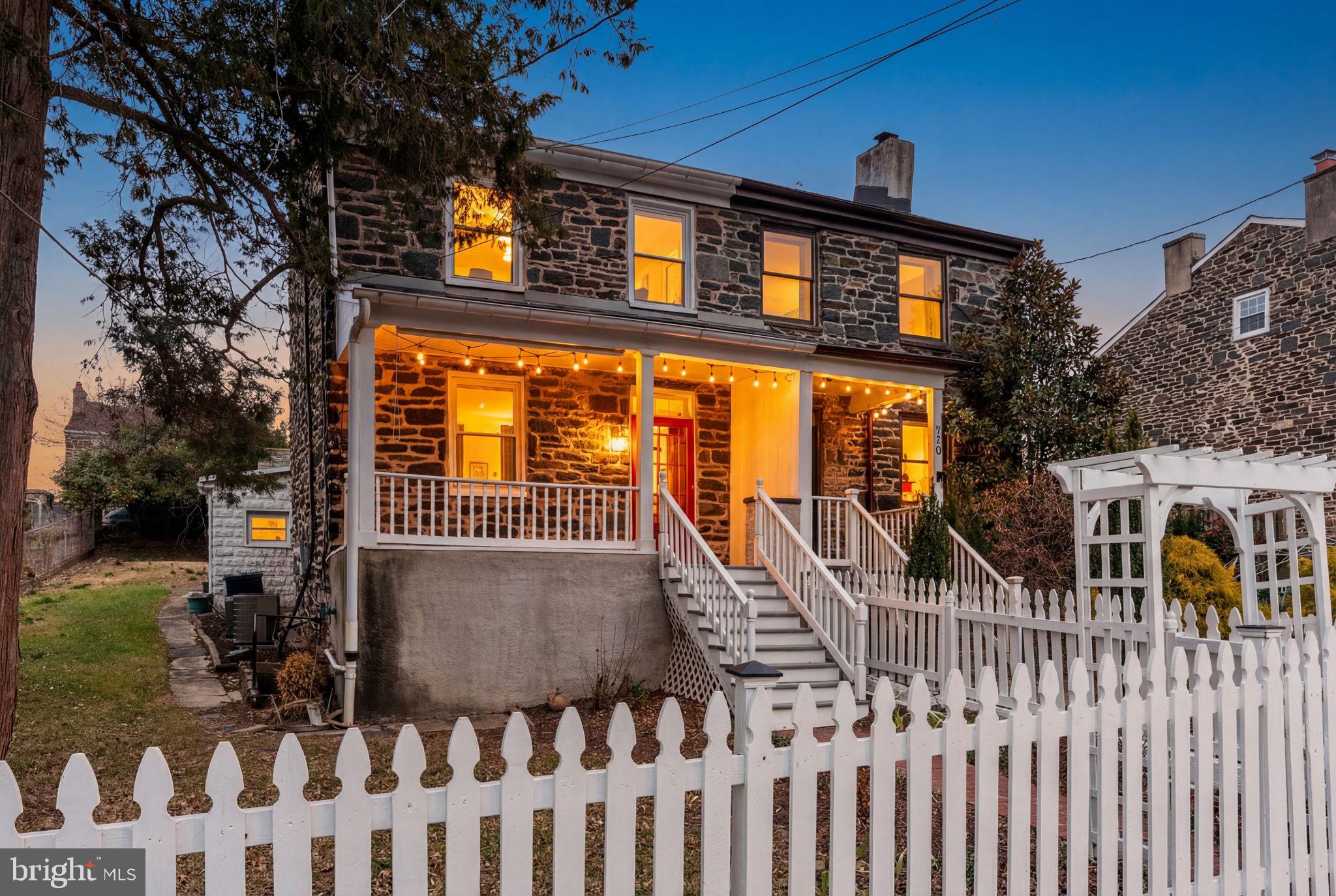a view of a house with wooden fence