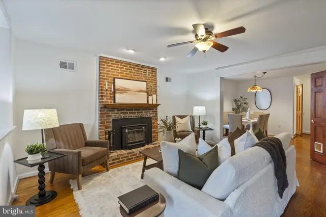 a living room with furniture a fireplace and a window