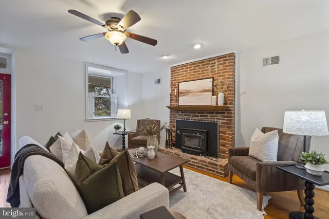 a living room with furniture fireplace and a window