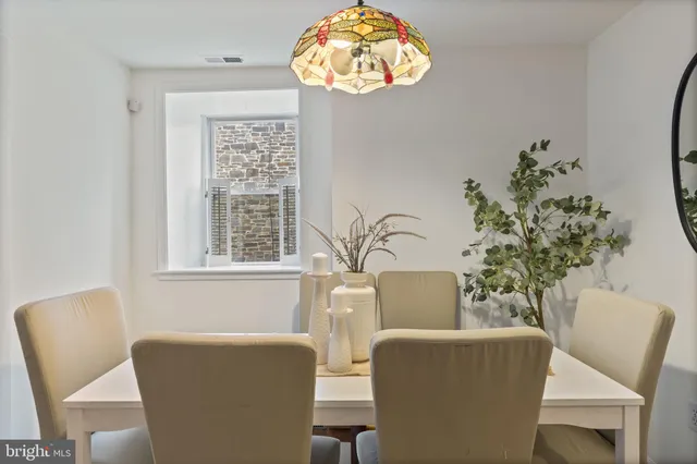 a view of a dining room with furniture and chandelier