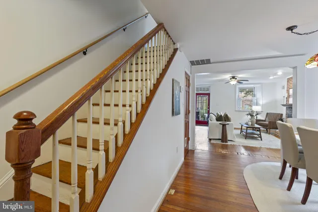 a view of entryway and hall with wooden floor