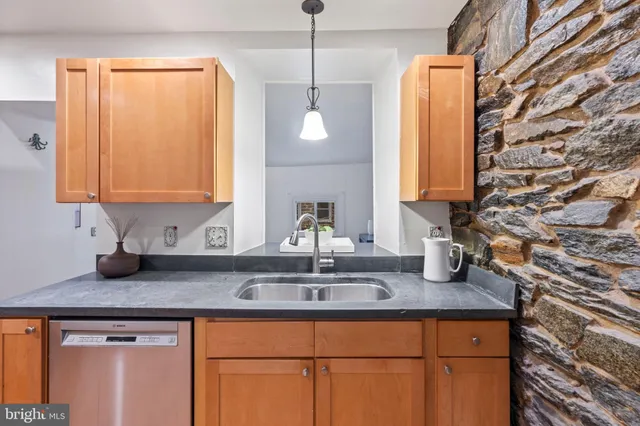 a kitchen with a sink and cabinets