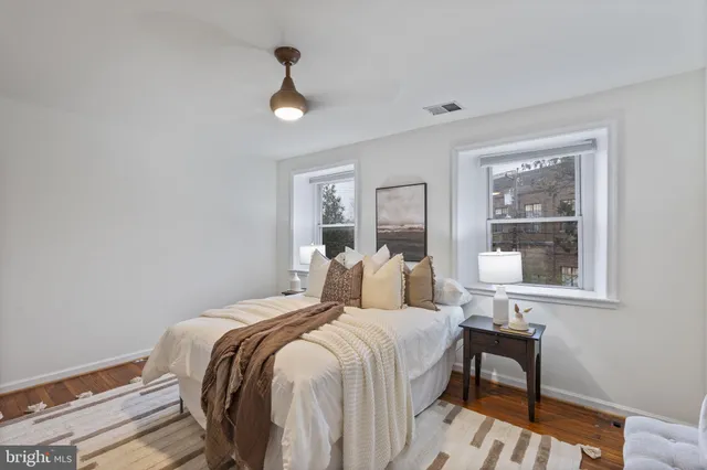 a bedroom with a bed and a painting on the wall