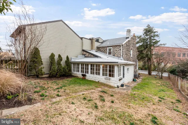 an aerial view of a house with a yard and lake view