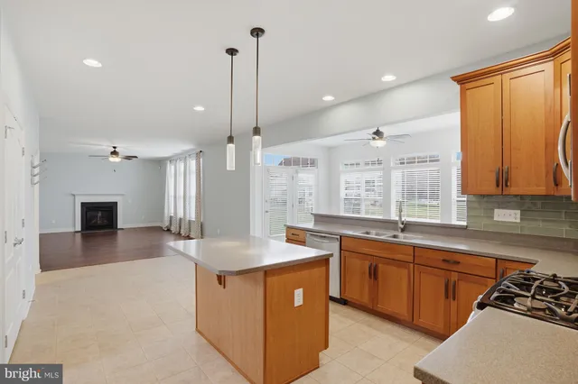 a kitchen with a sink stove and wooden cabinets