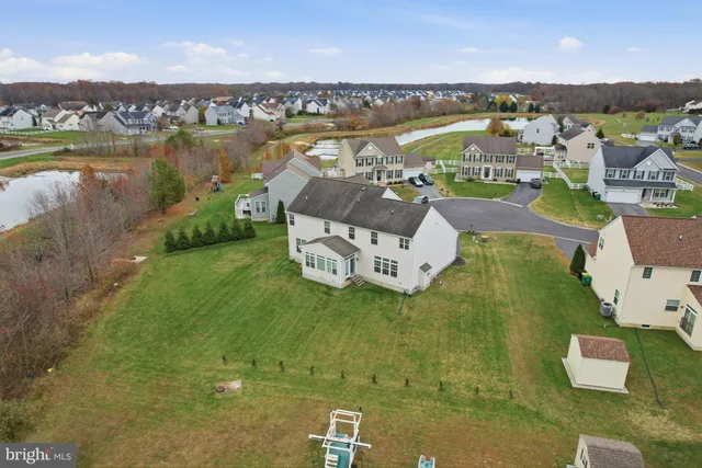 an aerial view of a house with a lake view