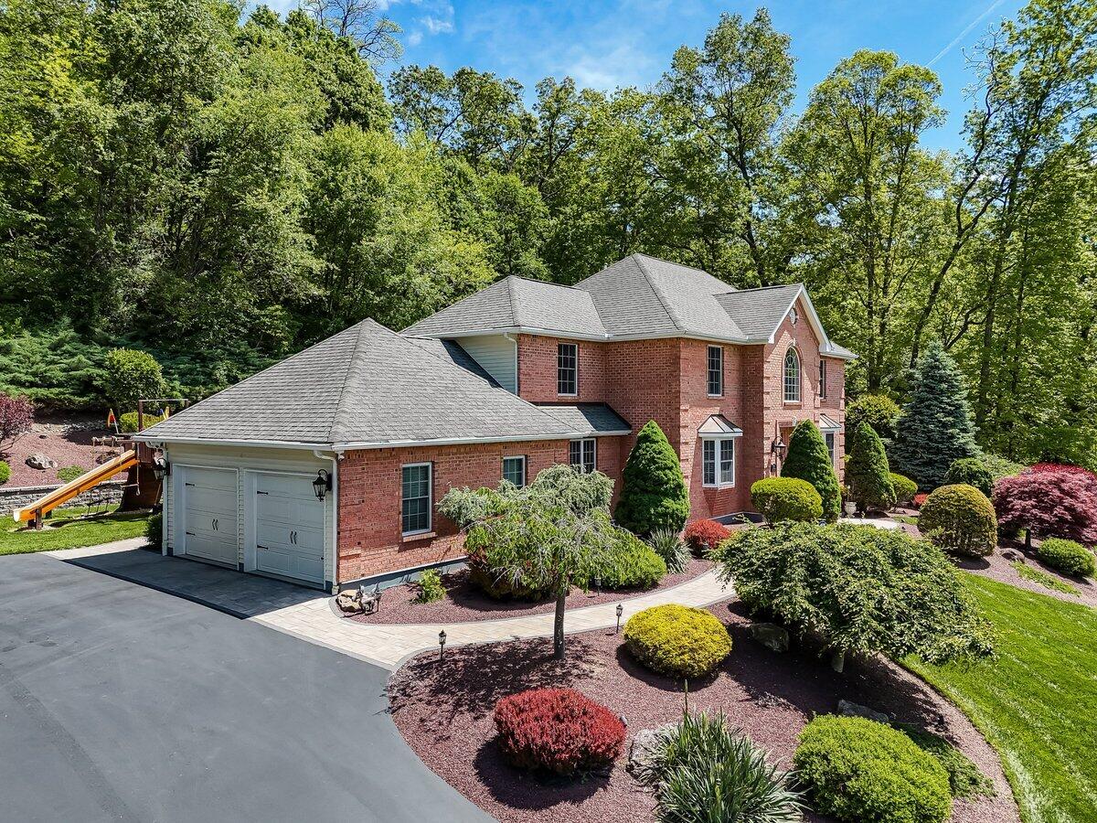 1376 Buck Ridge Drive Stroudsburg, PA 18360 - Photo 2 of 56 a view of a house with a garden and yard