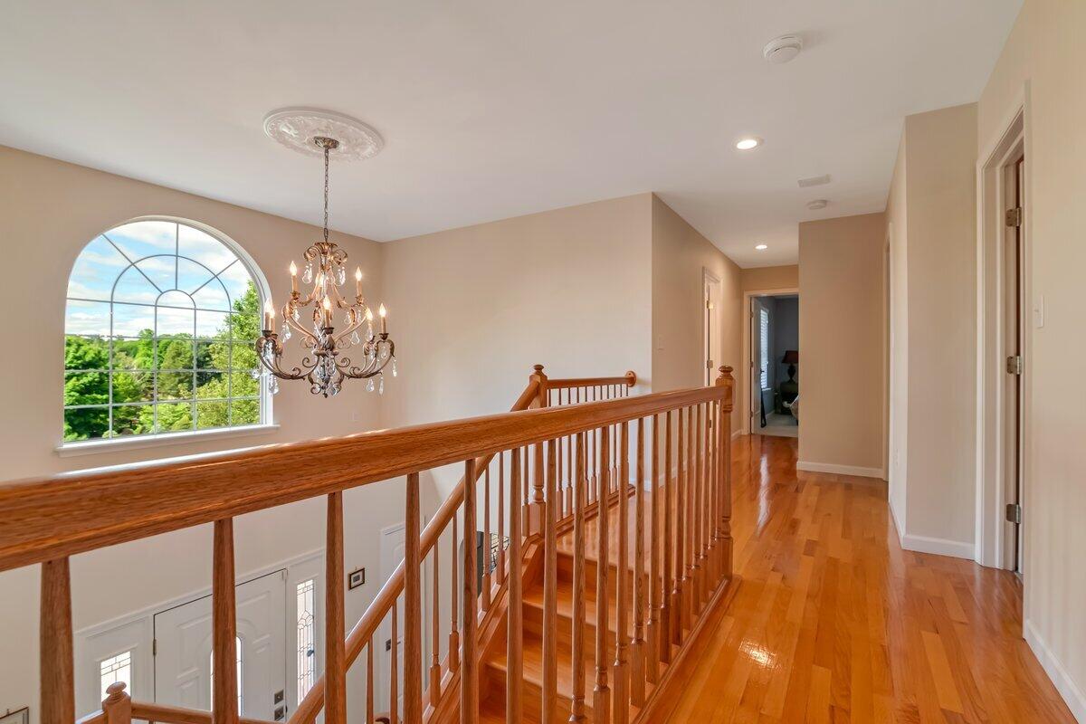 1376 Buck Ridge Drive Stroudsburg, PA 18360 - Photo 24 of 56 a view of a room with wooden floor chandelier and windows