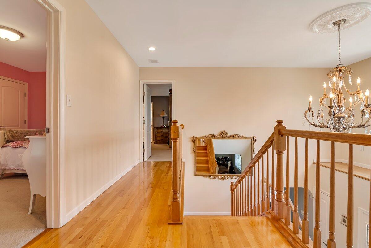 1376 Buck Ridge Drive Stroudsburg, PA 18360 - Photo 25 of 56 a view of a hallway with wooden floor and a living room
