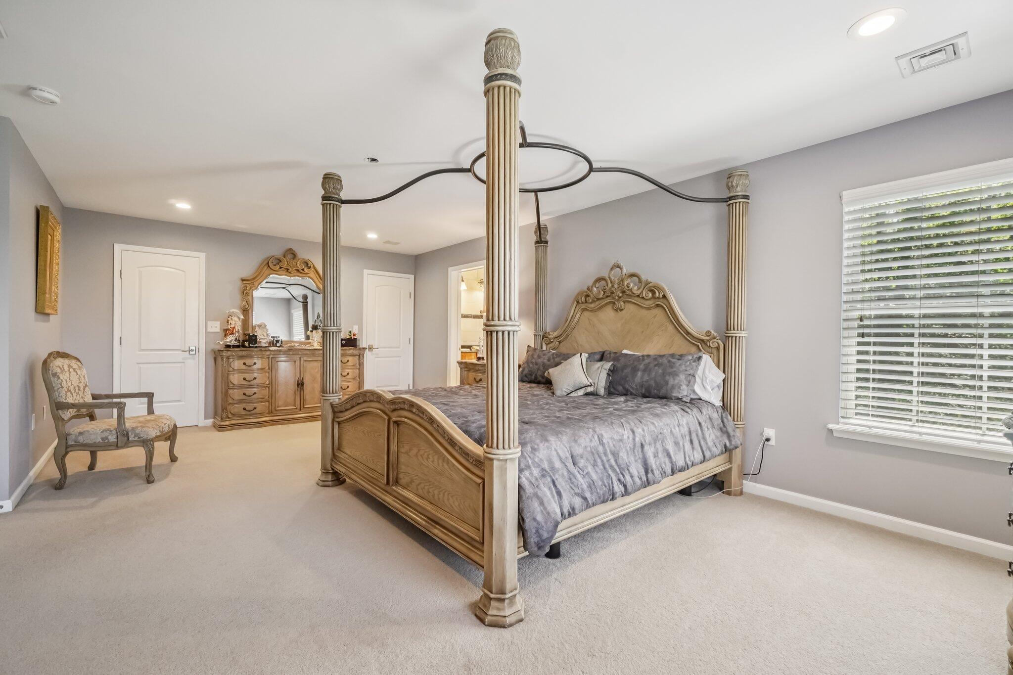 1376 Buck Ridge Drive Stroudsburg, PA 18360 - Photo 27 of 56 a spacious bedroom with a bed mirror and window