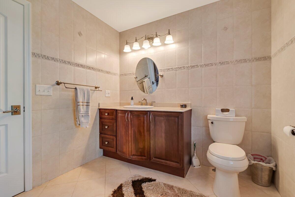 1376 Buck Ridge Drive Stroudsburg, PA 18360 - Photo 34 of 56 a bathroom with a toilet a sink and mirror